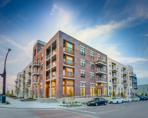 a large brick building with cars parked in front of it