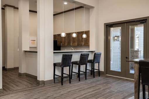 A modern kitchen with dark wood floors and a white countertop.