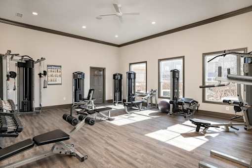 A spacious home gym with a variety of equipment.