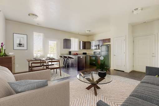 a living room and kitchen with a couch and a table