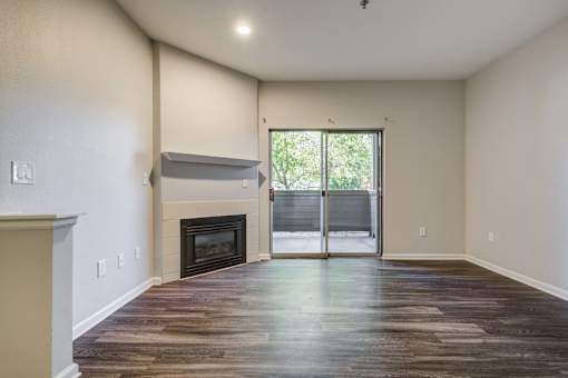 A room with a fireplace and sliding glass doors.