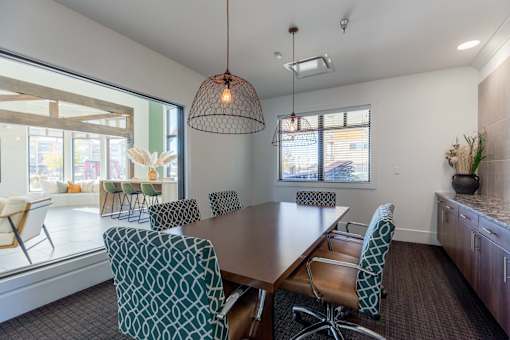 A conference room with a long table and chairs.