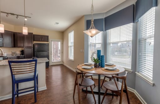 a dining room with a table and chairs and a kitchen