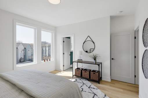 A bedroom with a large bed and a window overlooking a residential area.at The Yarra, Tennessee, 37115