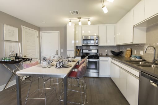 a kitchen with white cabinetry and stainless steel appliances