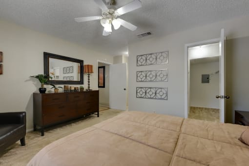 a bedroom with a large bed and a dresser