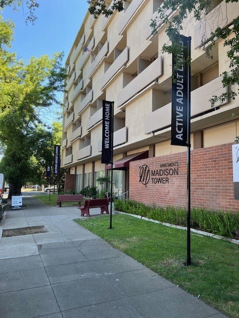 the madison tower on the side of a building with signs