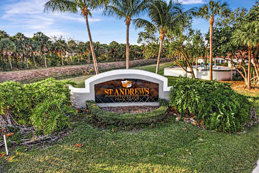 A sign that says "St. Andrews Golf Club" is in front of some trees.