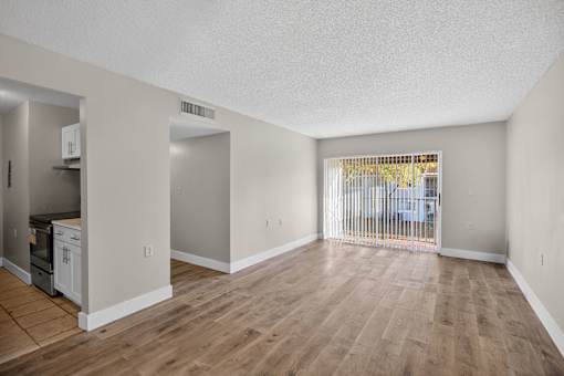 A room with wooden floors and white walls.