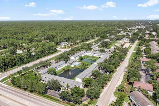 A bird's eye view of a residential area with a road running through it.