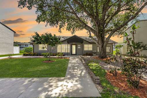 A house with a tree in front of it.