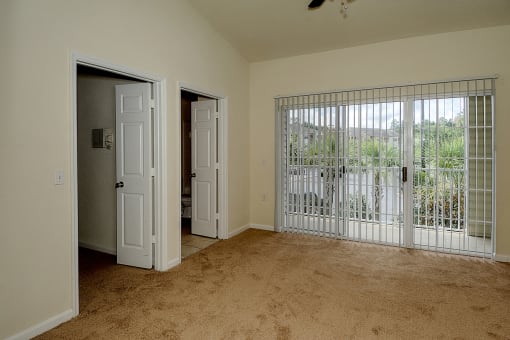 Interior Bedroom Sliding Glass at Magnolia Place Apartment, Gainesville