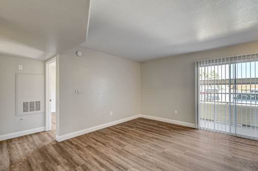 A room with a slanted ceiling and wood flooring.
