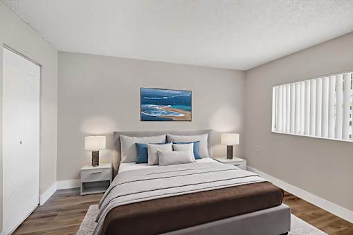 A bedroom with a large bed and a painting on the wall.