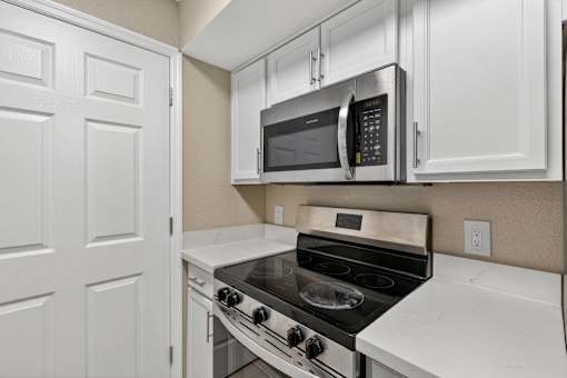 Kitchen with Stove top oven at Mer Soleil Apartments, Naples