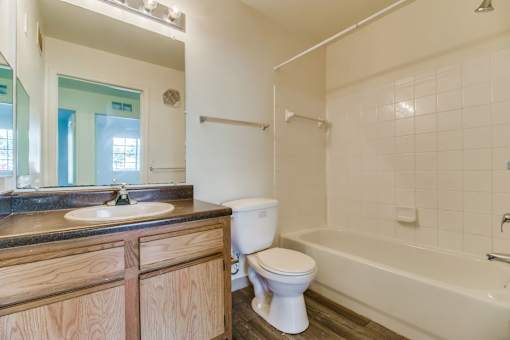 A white toilet sits next to a sink in a bathroom.