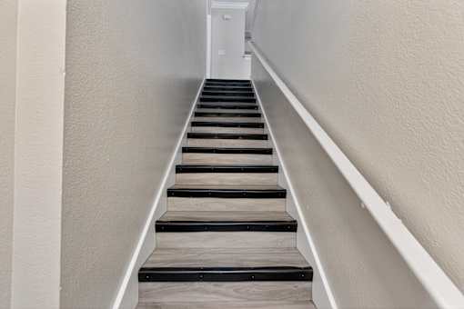 Staircase with wooden steps at Mer Soleil Apartments, Naples, FL, 34116
