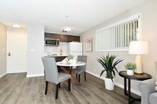 A dining room with a table set for two.