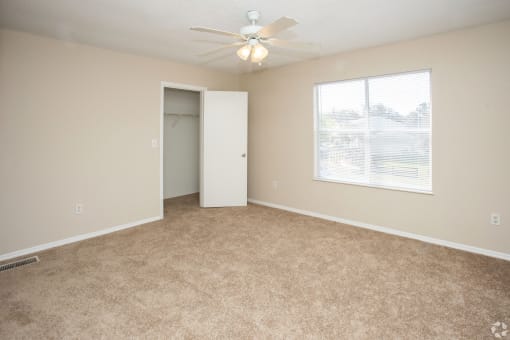 Bedroom with ceiling fan and light and window at  Springbrook Townhomes Apartments,Tallahassee, Florida,32303