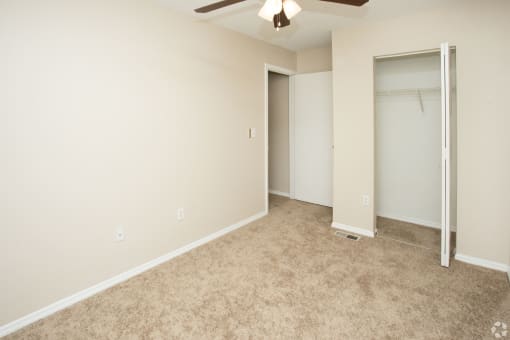 Bedroom with ceiling fan and light at Springbrook Townhomes Apartments,Tallahassee, Florida, FL
