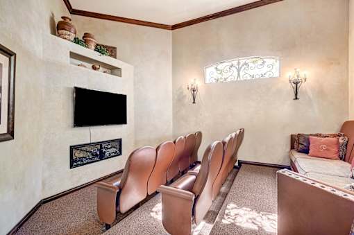 Theater room with leather seating and flatscreen tv at Borgata Condominiums Apartments, Las Vegas, NV