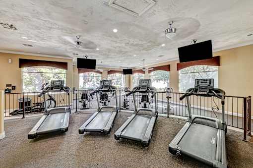 Fitness center with multiple treadmills and televisions at Borgata Condominiums Apartments, Las Vegas, Nevada