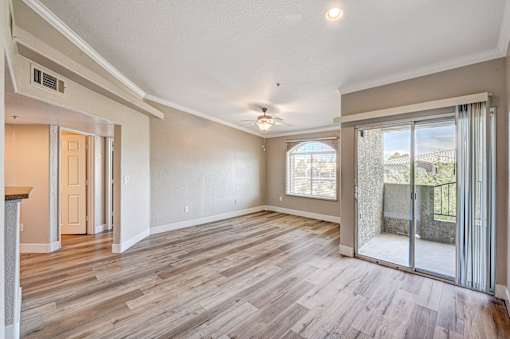 Open living room with sliding glass door at Borgata Condominiums Apartments, Nevada