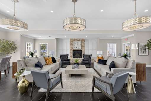 Spacious community room with fireplace and seating at The Ivy at Gatehouse Apartments, Orlando