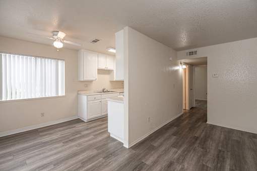 A kitchen with white cabinets and a sink.