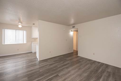 A room with a wooden floor and a door on the right side.