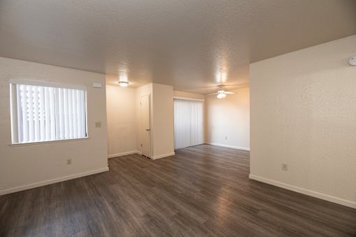A room with wooden floors and white walls.