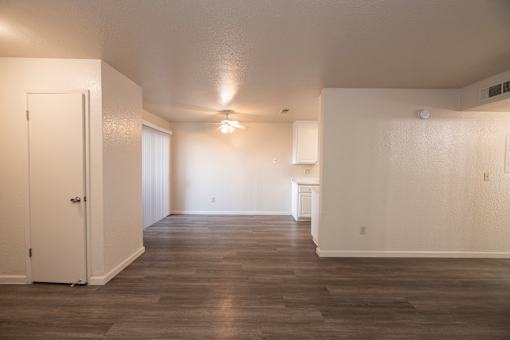 A room with a wooden floor and white walls.