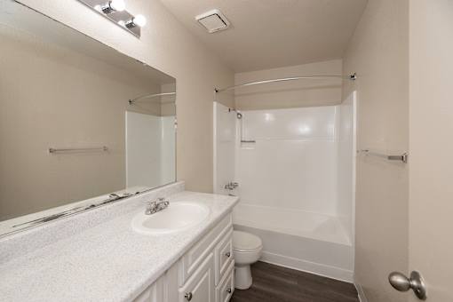 A white bathroom with a toilet and sink.
