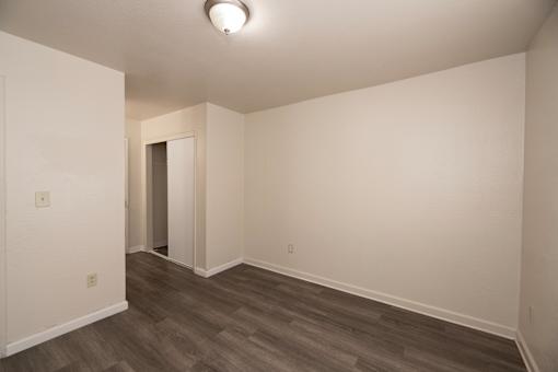 A room with a wooden floor and white walls.