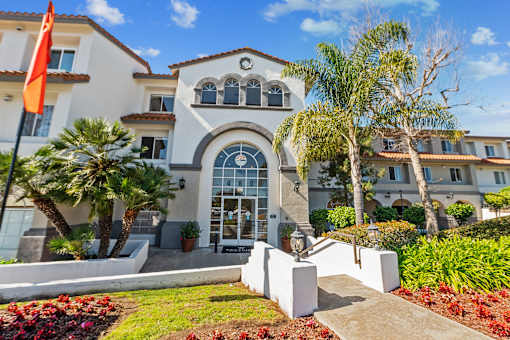 an  apartment building with palm trees in front of it at Azure Point at Encinitas, Encinitas, CA