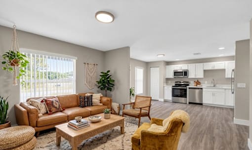 A living room with a brown sofa and a wooden coffee table.