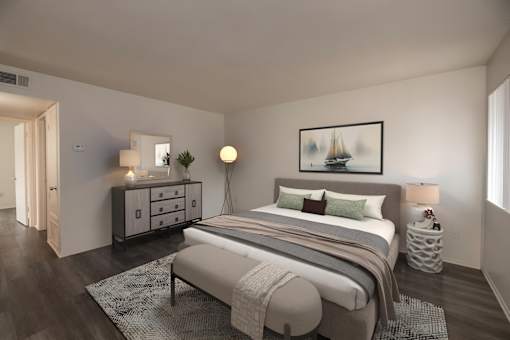 A bedroom with a bed, nightstands, and a painting on the wall.