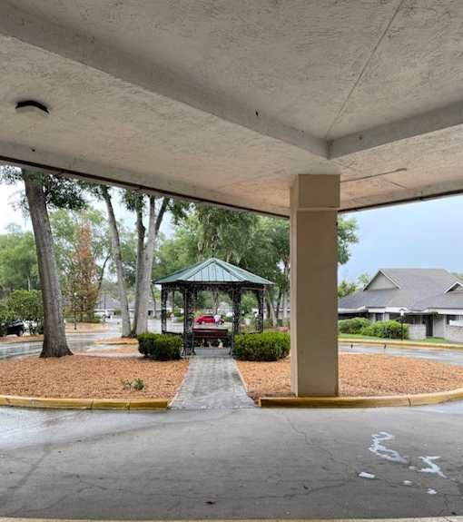 A gazebo is located under a covered walkway.