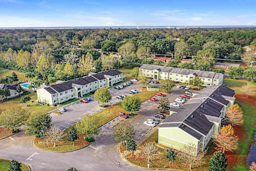 A large building complex with a parking lot in front.