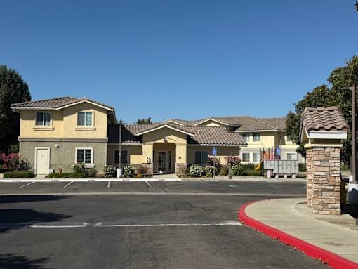 A row of houses with a red curb in front.