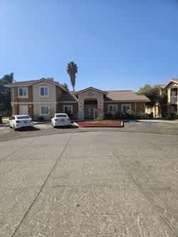A house with a driveway and two parked cars.