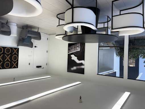 A modern interior with white walls and a large window.