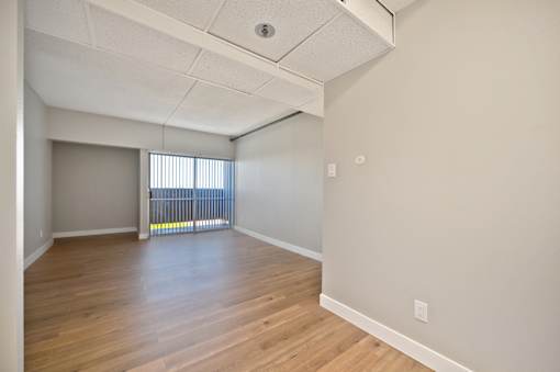 A room with wooden floors and white walls.