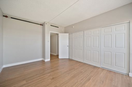 A room with a white door and a white wardrobe.