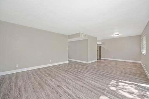 A room with wooden flooring and a white ceiling.