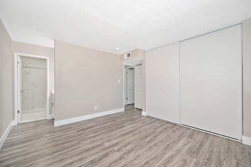 A room with a wooden floor and white walls.