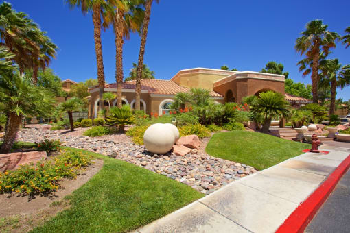 a home with palm trees and a globe in the front yard