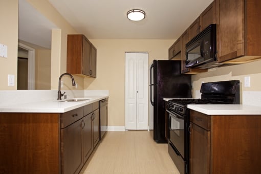 a kitchen with a stove refrigerator and a sink