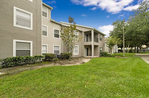 A grassy area in front of apartment buildings.