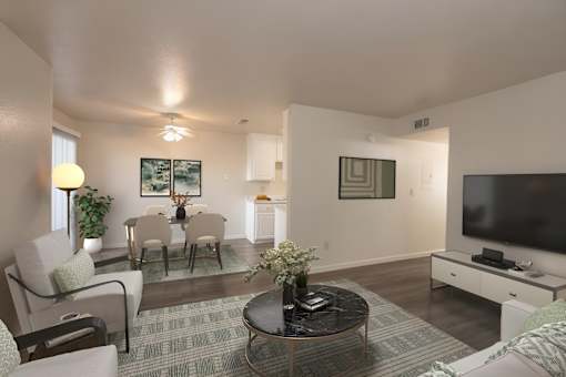 A living room with a grey carpet and a black coffee table.